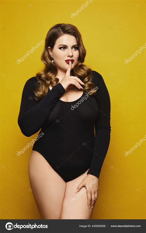 Plus Size Sexy Model Girl With Bright Makeup In Black Bodysuit Saying Hush And Posing At The