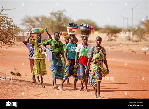 Women Arrive In The Town Of Djibo Burkina Faso On Foot Carrying