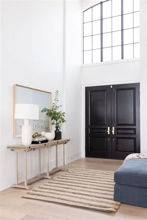 Taupe leather and wooden vintage dining chairs sit on a tan and brown wool rug surrounding a. Our Entryway Two-Day Transformation with Studio McGee ...
