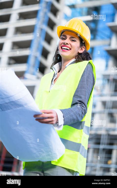 Female Civil Engineer Studying Drafts Visiting Construction Site Stock