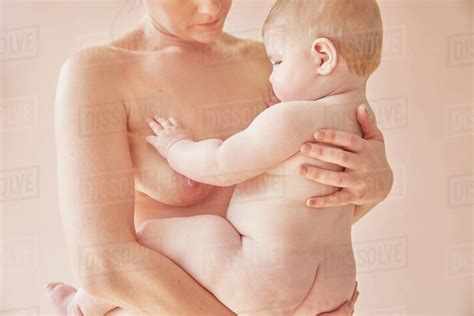 Naked Mother Carrying Naked Baby In Arms Stock Photo Dissolve