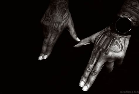 28 Funky Gun Tattoos On Hand Tattoo Designs
