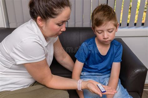 Mother Doing The Covid Rapid Antigen Test For Her Son Stock Image