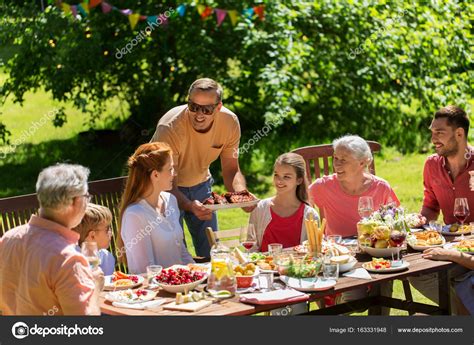 Affordable and search from millions of royalty free images, photos and vectors. Happy family having dinner or summer garden party — Stock ...