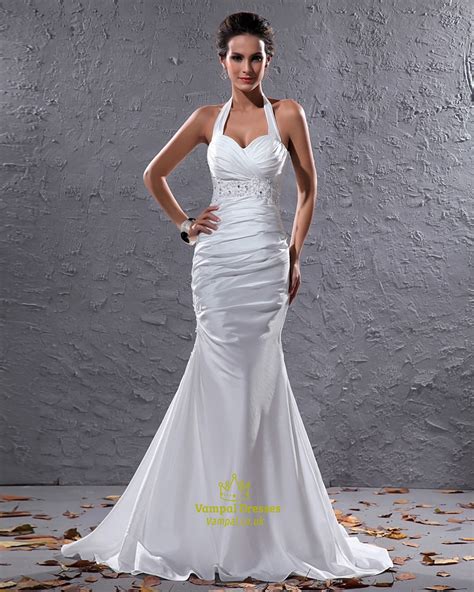 A wedding dress is perhaps the most carefully chosen dress a woman will ever wear. Elegant White Halter Neck Floor Length Lace Embellished ...