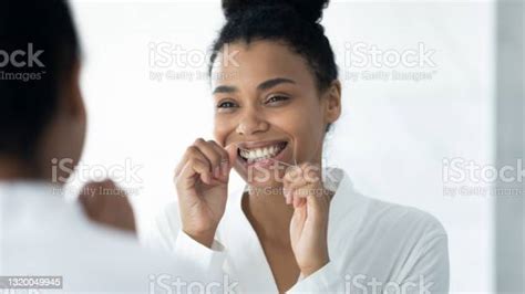 Happy Black Girl In Bathrobe Cleaning White Teeth With Floss Stock