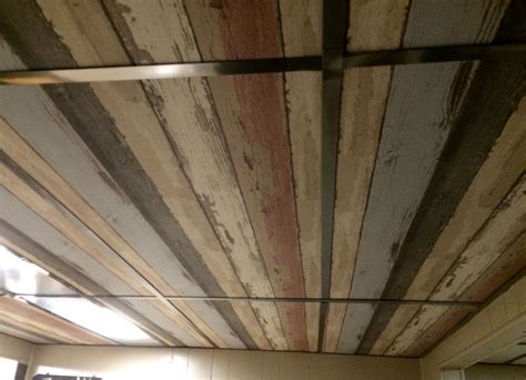 Because drop ceilings are ugly and panel walls look like shit. Dropped ceiling - I wallpapered the old ceiling tiles. I ...