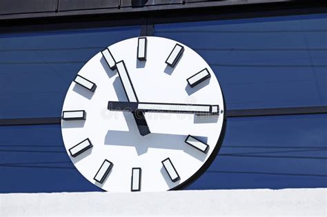 A Large White Clock With Hands On Station Building Stock Photo Image