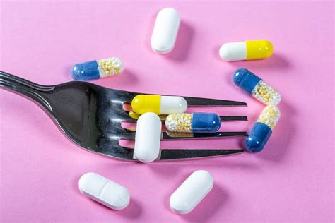 Colorful medicines and pills with a Cup of tea and lemons. Concept folk ...