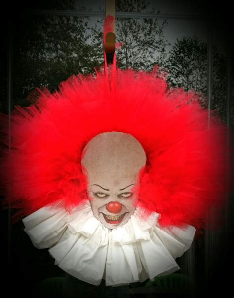 A Creepy Clown With Red Hair And White Face