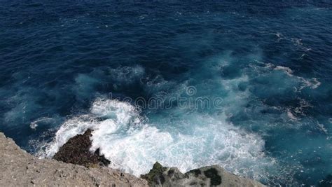 Sea Waves Hit The Rocks Of The Island In Bali Indonesia Stock Photo