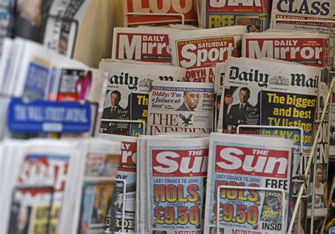 British Newspapers Are Displayed At A Newsagents Stand In Central