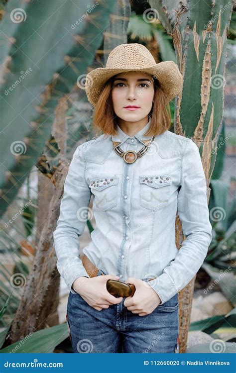 Woman In Western Wear In Cowboy Hat Jeans And Cowboy Boots Stock