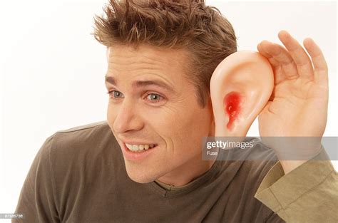 Man Cupping Hand Over Big Ear High Res Stock Photo Getty Images