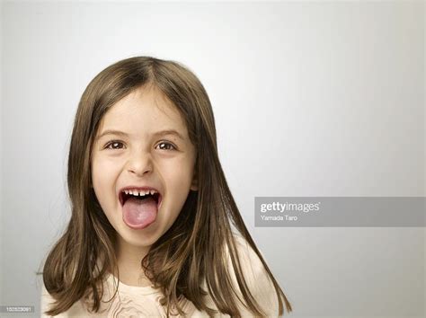 Portrait Of Girl Sticking Out Tongue Photo Getty Images