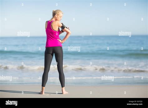 Sportswoman Using Mobile Phone On Beach Stock Photo Alamy