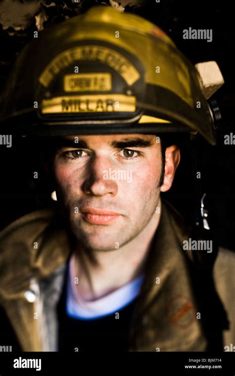 Portrait Of A Firefighter With Fire Hose Stock Photo Alamy
