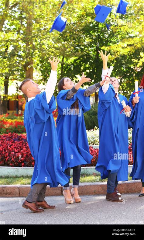 Students Throwing Graduation Hats In Air Outdoors Stock Photo Alamy