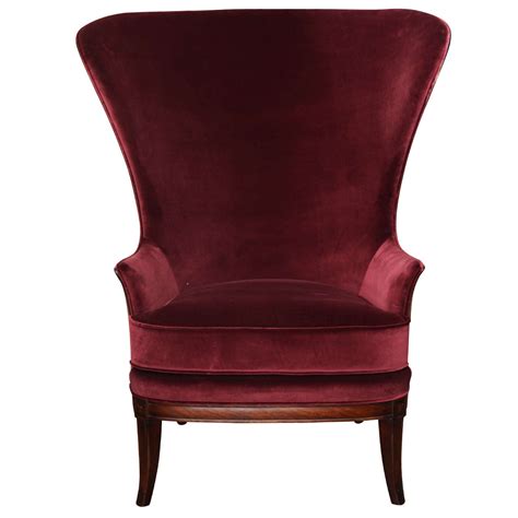 He betty wing chair is designed with the extravagance and poise that lures the eyes with its curves and upholstered tight back. Red Velvet Wing Chair, circa 1930