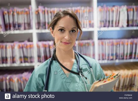 Portrait Confident Nurse With Medical Records Stock Photo Alamy