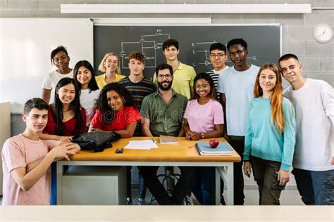 Large Group Portrait Of Millennial Students With Male Teacher In
