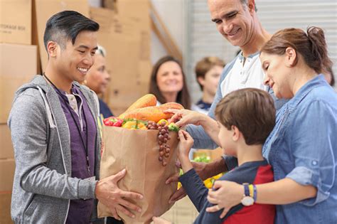 During this time i have met some lovely people at the warehouse and. Multiethnic Group Of Volunteers Work At Food Bank Stock ...