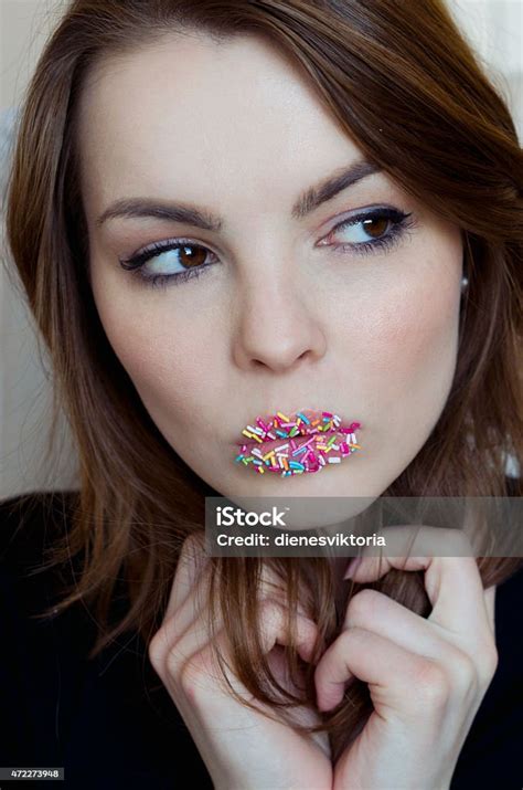Woman Has Candies On Her Lips Stock Photo Download Image Now 2015