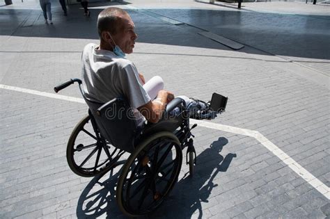 Middle Aged Man With A Broken Leg In A Cast In A Wheelchair On A Walk
