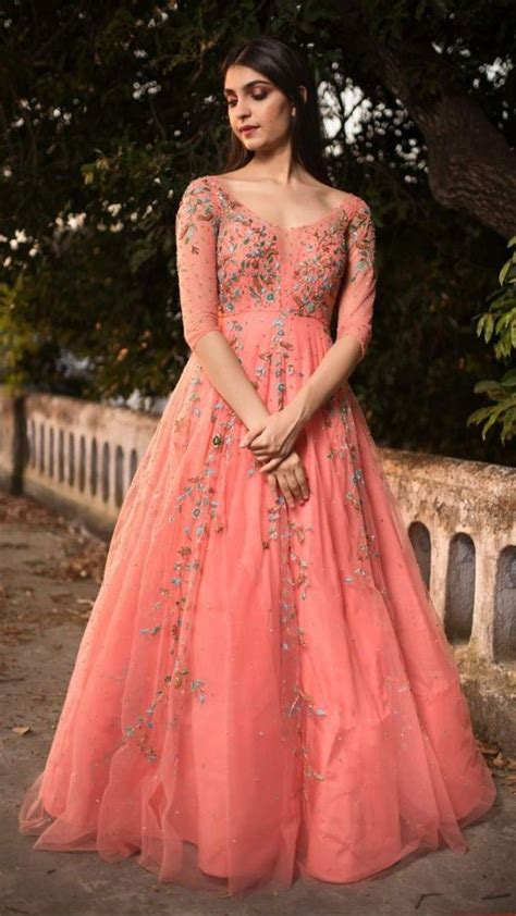 Kurta is a long loose shirt, the length of which falls below or may be just above the knees of the wearer. Beautiful Net embroidered Long Gown with traditional ...