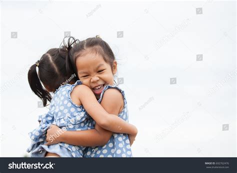 Happy Two Asian Child Girls Hugging Stock Photo 692762476 Shutterstock