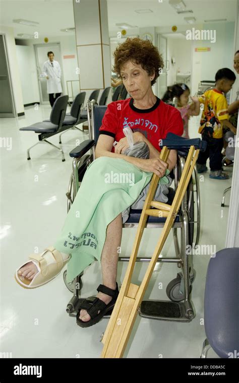 Female Patient In The Pushcart Using Crutches Cast On Leg Thailand