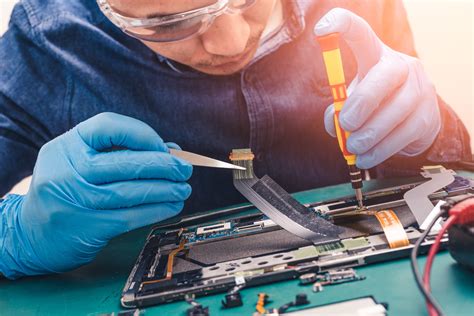 The Abstract Image Of The Asian Technician Repairing Inside Of Tablet