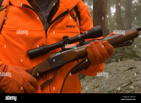 A Deer Hunter In Blaze Orange Holding Ruger Model One 3006 Rifle With