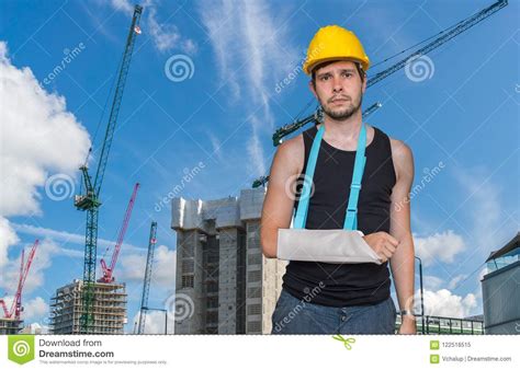 Injured Worker Is Wearing Medical Sling On His Arm Construction Site