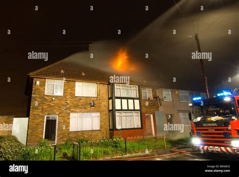 Firefighters From A Fire And Rescue Service Uk Tackle A Bedroom House