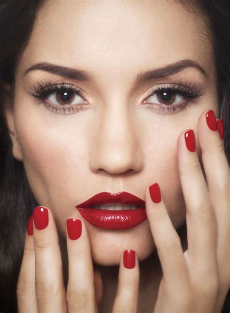 Red Lipstick And Nail Polish Against Porcelain Skin