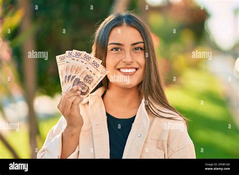 Young Hispanic Girl Smiling Happy Holding Mexican 500 Pesos Banknotes