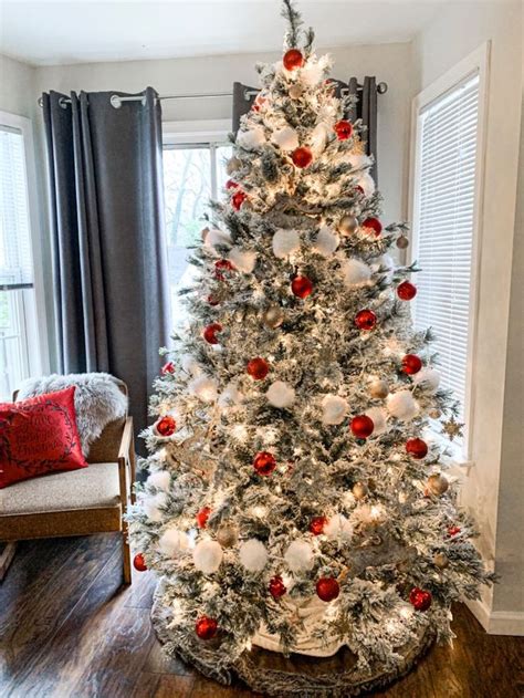 A Decorated Christmas Tree In A Living Room With Red And White