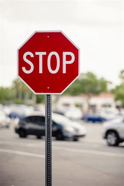 Octagonal Red And White Stop Sign In The Foreground Of A Busy Parking Lot Stock Image Image Of