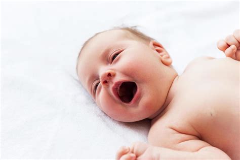 Crying Baby Top View Of Little Baby Lying In Bed And Crying 13556615