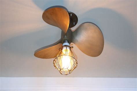 The propeller is a ceiling fan and main ceiling lighting at one and the same time. Brass bronze boat Propeller Ceiling Light 16" marine ...
