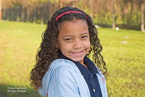 curly headed mix race seven year old girl portrait mary kate denny