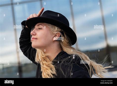 Portrait Of A Blonde Woman Wearing A Hearing Aid Stock Photo Alamy