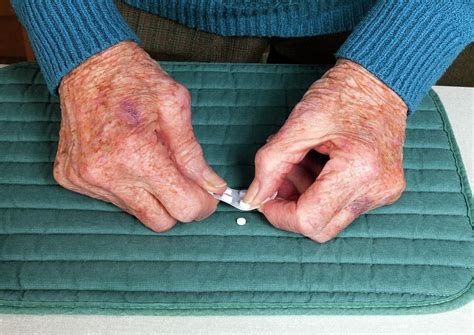Elderly Woman Popping Pills Photograph By Paul Rapsonscience Photo