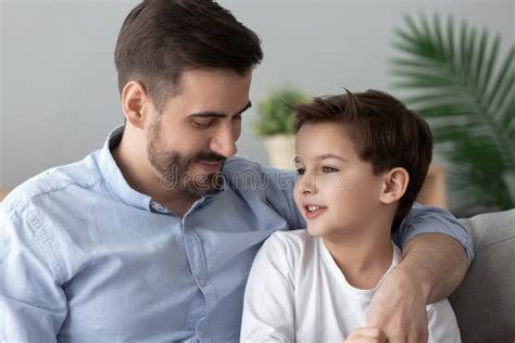 Loving Father Hugging Talking With Little Son Spending Time Together