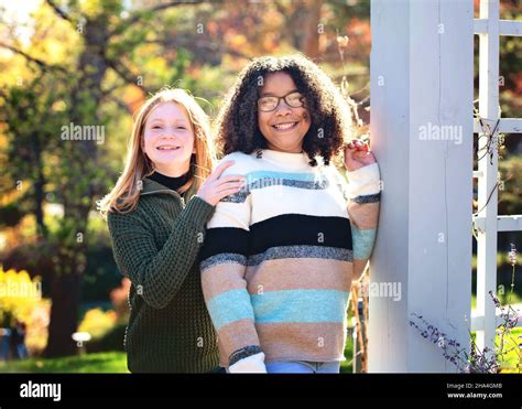 Two Happy Tween Girls Outdoors In Fall Colors Stock Photo Alamy