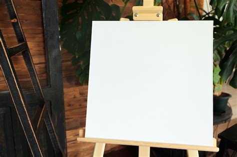 Premium Photo Blank White Canvas On Wooden Easel