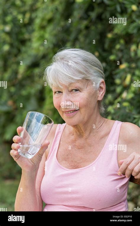 70 Year Old Woman Drinking Water Hi Res Stock Photography And Images