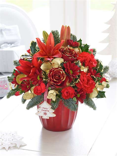 Purchases come with a free card message. I would send this Festive Red and Gold Arrangement to both ...