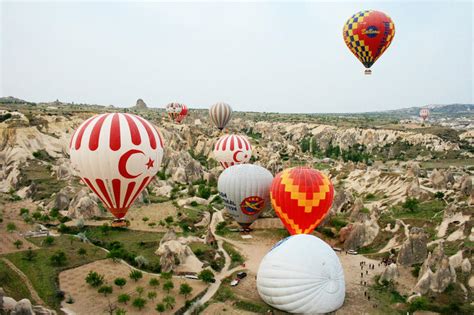 Hot Air Balloon Flying Over Rock Landscape At Cappadocia